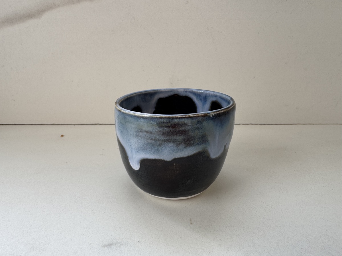 Raw phone photo of a ceramic cup